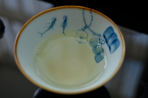 Green Puerh wedding cake tea from Lake Missoula Tea Company, showing a dense, pressed tea cake with rich green color.
