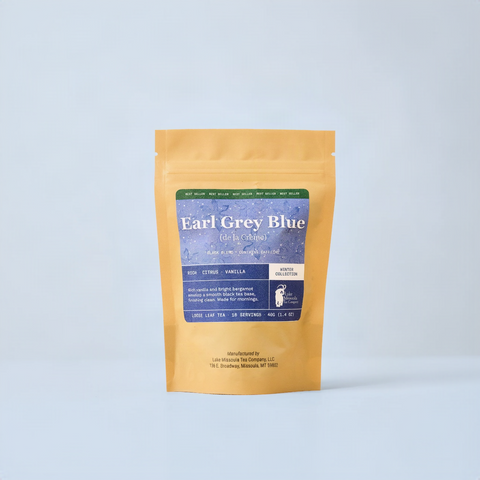Earl Grey Blue winter collection packaging on blue background. Tan 2oz bag with blue label.