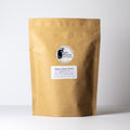 Sakura Cherry Green tea by Lake Missoula Tea Company in a 500g package, featuring fresh green tea leaves with cherry blossom and cherry accents.