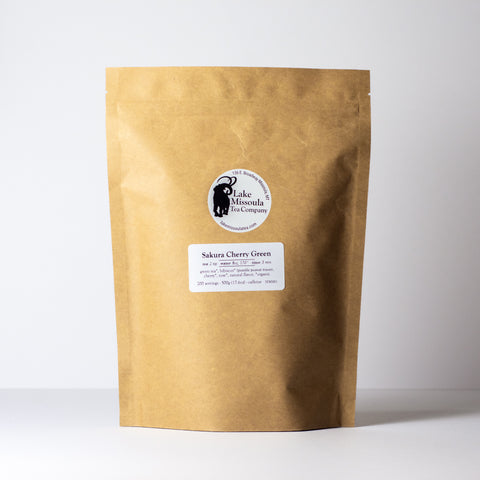 Sakura Cherry Green tea by Lake Missoula Tea Company in a 500g package, featuring fresh green tea leaves with cherry blossom and cherry accents.