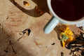 A cup of Lake Missoula Tea Company's Classic Chai tea with cinnamon sticks and cloves on a rustic wooden table.