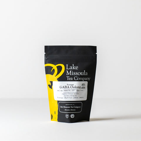 Dried GABA Oolong tea leaves from Lake Missoula Tea Company in a 20g package, showcasing the rolled, dark tea leaves.