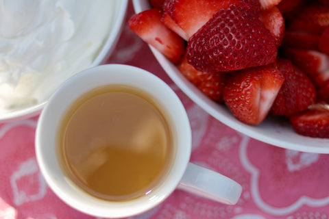 Creamy strawberry milkshake tea in a Geneva bowl, featuring a vibrant pink color and fresh strawberry garnish, by Lake Missoula Tea Company.