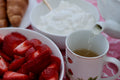 Creamy strawberry milkshake tea from Lake Missoula Tea Company poured into a bowl with a teapot, in a cozy kitchen setting.