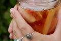 Glass of Belly Bliss tea with raspberry leaf and strawberries, served with ice, by Lake Missoula Tea Company.