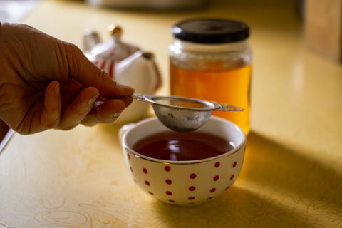 Horizontal image of Lake Missoula Tea Company's Scheherazade Shai tea packaging with a tea cup and leaves.