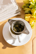 Lake Missoula Tea Company LMTC Steeper with jasmine pearl tea in a cozy sweater weather setting, perfect for brewing tea.
