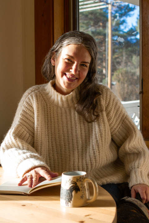 A steaming cup of Irish Breakfast tea from Lake Missoula Tea Company, served with a teapot and teacup on a rustic table.