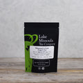 Two ounces of Lake Missoula Tea Company's Maureen's Cure Singer's Tea in a clear glass jar, showing the herbal tea blend.
