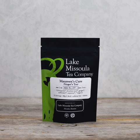 Two ounces of Lake Missoula Tea Company's Maureen's Cure Singer's Tea in a clear glass jar, showing the herbal tea blend.