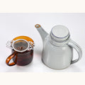 Golden Snail tea in a Nepali-style tea pot by Lake Missoula Tea Company, showcasing a traditional brewing setup.