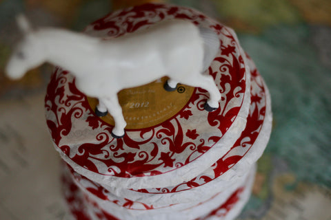 Green Puerh wedding cake tea from Lake Missoula Tea Company, showing a traditional compressed tea cake with green tea leaves.