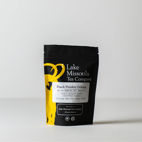 Bag of Peach Peridot Oolong tea by Lake Missoula Tea Company, showing the colorful loose leaf tea blend in a clear bag.