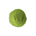 Fine powder of Lake Missoula Tea Company's Instant Matcha tea in a clear container with a spoon.