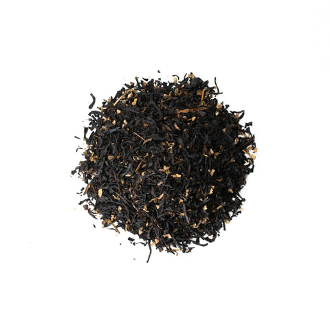 A cup of raspberry patch tea from Lake Missoula Tea Company with fresh raspberries and tea leaves in a rustic setting.