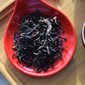 Sangamon Sunset Red tea from Lake Missoula Tea Company displayed on a tray with loose tea leaves and a cup.