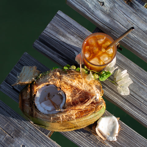 Square image of Lake Missoula Tea Company's creamy coconut oolong tea in a cup with coconut flakes and tea leaves.