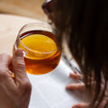 Square image of Lake Missoula Tea Company's creamy vanilla orange tea in a cup with a tea bag and fresh orange slices.