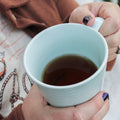 Square image of Lake Missoula Tea Company's Russian Caravan tea in a cozy outdoor fireplace setting.