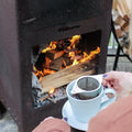 Russian Caravan tea from Lake Missoula Tea Company shown in a square image with an outdoor fireplace setting.