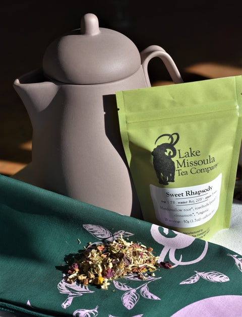 Loose leaf Sweet Rhapsody tea from Lake Missoula Tea Company in a teapot, showcasing vibrant tea leaves and brewing process.