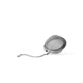 Stainless steel tea ball infuser from Lake Missoula Tea Company, shown open with loose tea leaves inside for brewing tea.