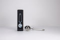 Metallic tea infuser with packaging on a white background