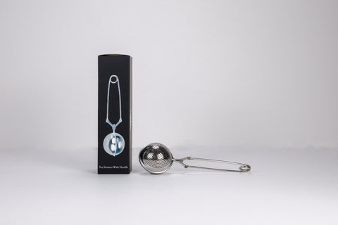 Metallic tea infuser with packaging on a white background