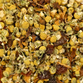Close-up of dried chamomile flowers for Lake Missoula Tea Company's Chamomile Calm tea, showcasing its calming herbal blend.