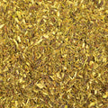 Close-up of dried green rooibos tea leaves showing their fine, textured green and reddish-brown hues from Lake Missoula Tea Company.