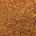 Close-up of Rugger's Rooibos tea from Lake Missoula Tea Company, showcasing its rich, textured dried tea leaves.