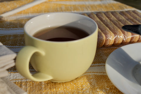 Lake Missoula Tea Company Tiramisu herbal tea in a teacup, showcasing a rich, creamy coffee-flavored tea with cocoa and mascarpone notes.