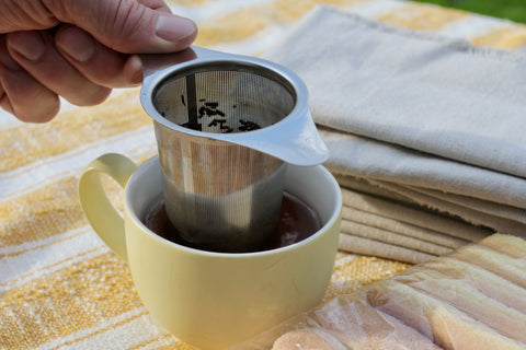 Lake Missoula Tea Company's Tiramisu tea in a clear glass cup, showcasing the layered dessert-inspired tea with a creamy topping.