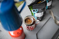 Cup of Good Hope tea by Lake Missoula Tea Company in a camping mug, showcasing a warm beverage and outdoor setting.