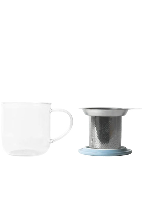 Glass mug with a metal tea infuser on a white background