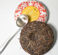 Green Puerh tea in a wedding cake-inspired presentation by Lake Missoula Tea Company, showcasing layered green tea flavors