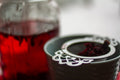Dried hibiscus tea leaves from Lake Missoula Tea Company, displayed in a jar on a winter gardening table.