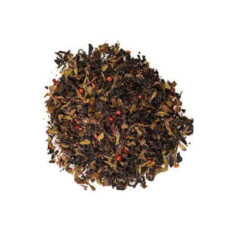 A cup of Rift Valley Currant tea by Lake Missoula Tea Company, showcasing a brewed tea with a rich, reddish hue in a white teacup.