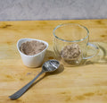 Cup of Lake Missoula Tea Company's INSTANT Chai tea with frothy milk, served in a white ceramic mug on a wooden surface.