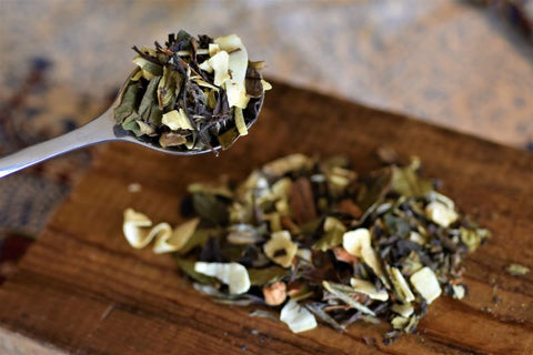 Lake Missoula Tea Company Cinnamon Chaga Spice Tea in a scoop, ready for brewing, showcasing warm spice and rich tea leaves.
