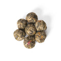 Small pile of Flowering Tea Double Happiness by Lake Missoula Tea Company, showcasing beautifully crafted blooming tea flowers.