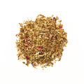 Cup of Sweet Rhapsody tea from Lake Missoula Tea Company with blooming herbal tea leaves and a floral aroma.