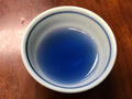 Blue butterfly pea flower tea in a cup, showcasing vibrant blue petals from Lake Missoula Tea Company's butterfly pea flower tea.