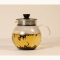 Green Puerh tea leaves steeping in a teapot, brewed by Lake Missoula Tea Company, showcasing rich green tea leaves.