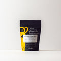 Cinnamon Chaga Spice tea by Lake Missoula Tea Company in a clear glass cup showing the brewed tea with cinnamon and Chaga mushroom spices.