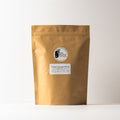 Creamy Coconut Oolong tea leaves from Lake Missoula Tea Company in a 500g package, showcasing golden-brown tea leaves with coconut flavor.