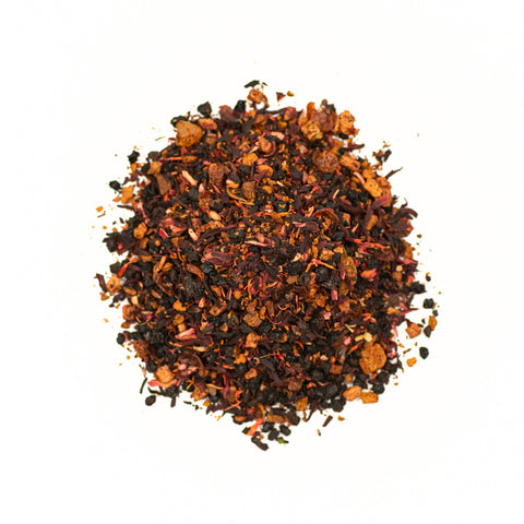 A cup of Pleistocene Peach tea by Lake Missoula Tea Company with fresh peach slices and herbal tea leaves on a rustic wooden table.
