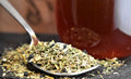 Cup of No Thyme for Cold & Flu herbal tea by Lake Missoula Tea Company in a mug with fresh thyme sprigs and lemon slices.