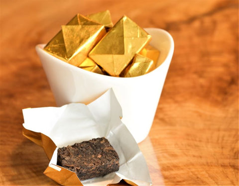 Golden Brick Puerh tea from Lake Missoula Tea Company, showing pressed golden-brown tea bricks with a textured surface.