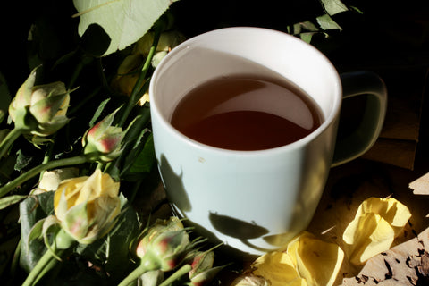 Dried black tea flowers in a wooden cup, from Lake Missoula Tea Company, showcasing the decaf black tea blend.